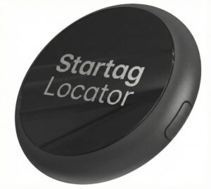 A round, black electronic device labeled Startag Locator with a small button on the side, designed for tracking or locating items.
